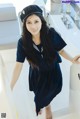 A woman in a sailor outfit standing on a boat.