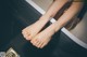 A woman's feet in a bathtub with water on them.