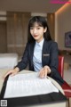 A woman in a business suit sitting at a table.