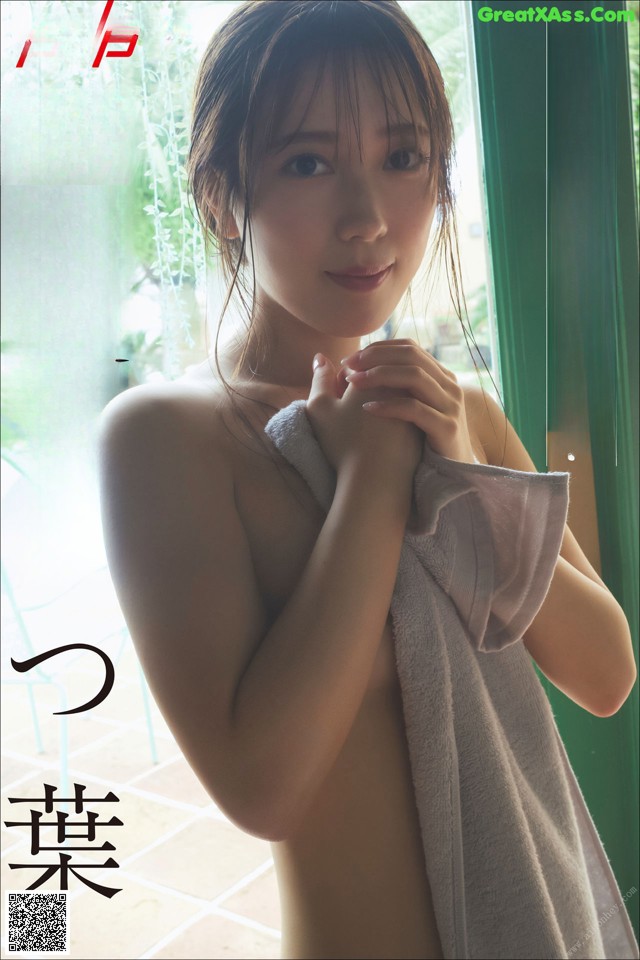 A naked woman with a towel wrapped around her body.