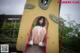 A woman is sitting on a slide in a park.